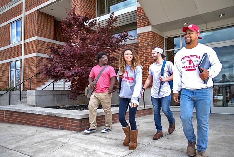 Students pose in housing quad